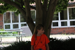 Junior journalist Hadley Hoskins enjoys the shade at the ECHO journalism camp, July 14.